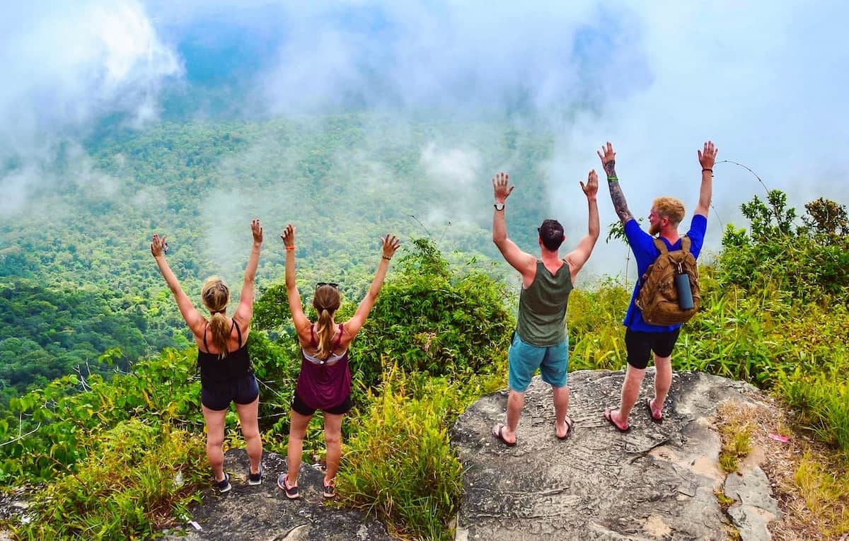 Backpackers enjoying a scenic viewpoint on a Cambodian island.