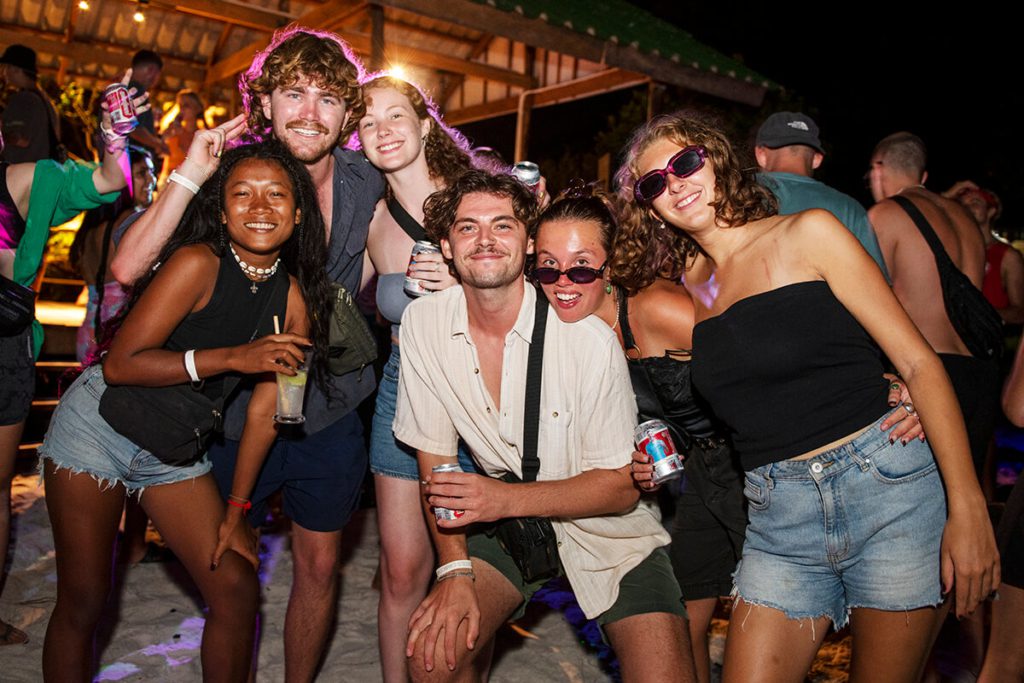 Southeast Asia backpacking with travelers meeting new friends at a night party
