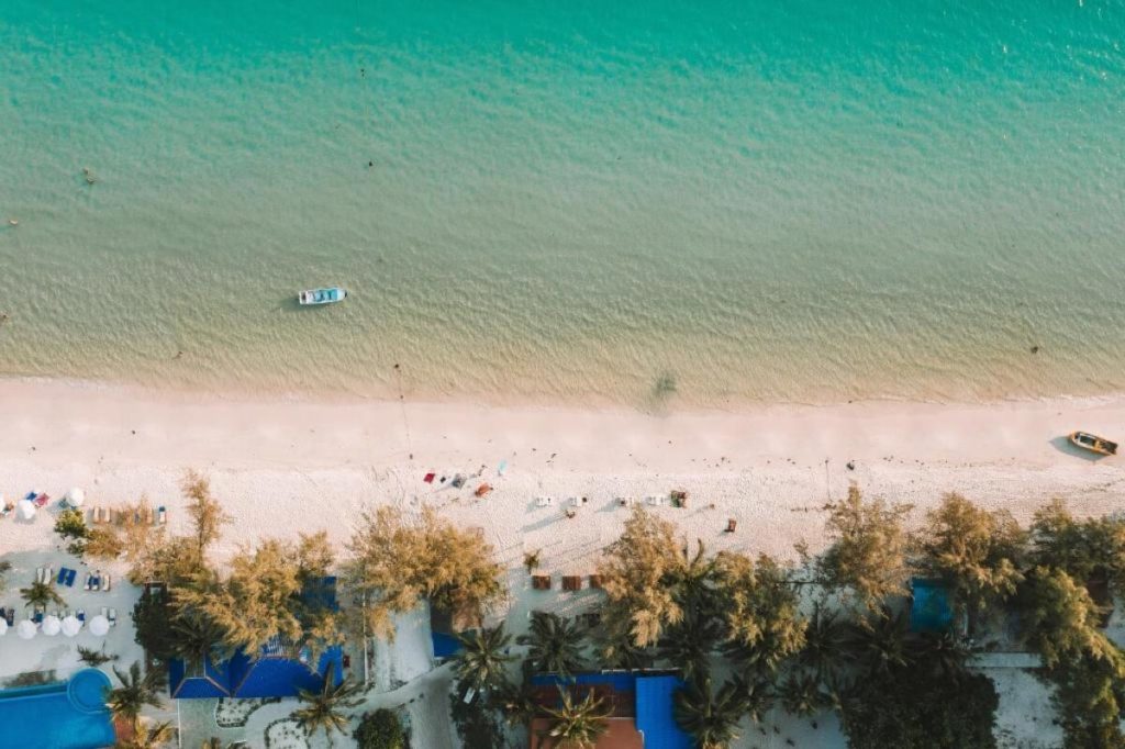 birds eye view of mad monkey hostel facing out to the azzure blue ocean and white sandy beach