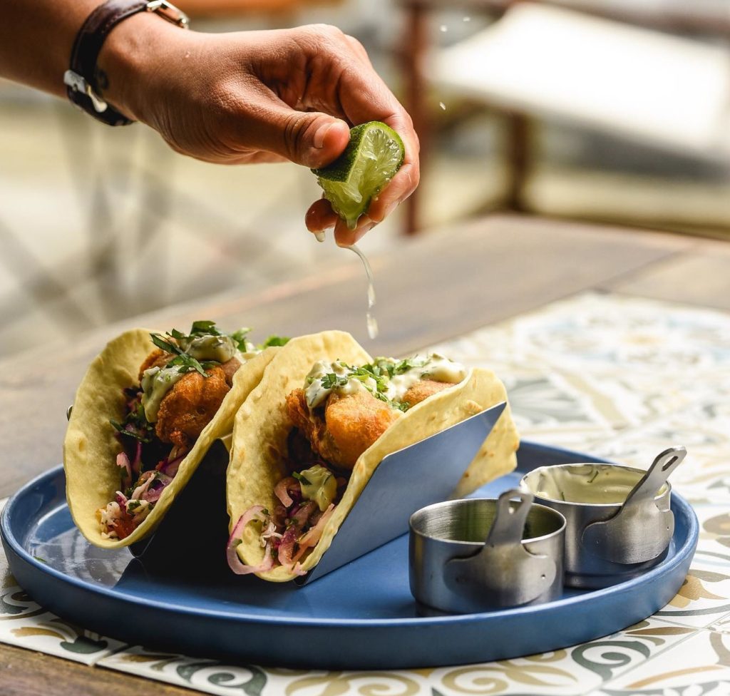 fresh limed being squeezed over tacos at Hoi An's best restaurant, Nourish Eatery