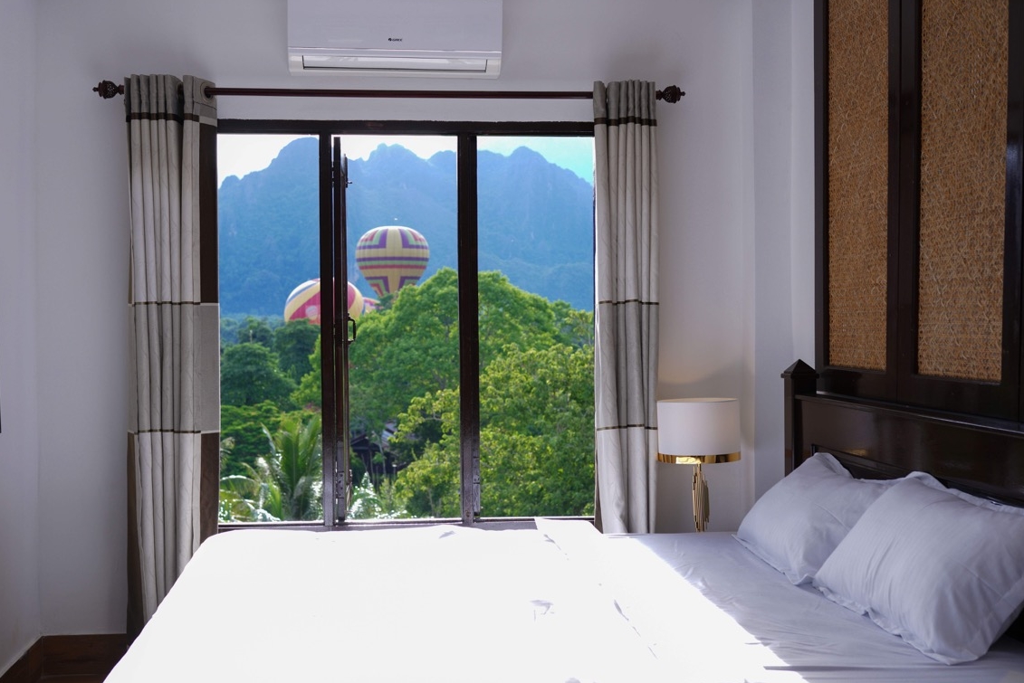 View of the mountains and hot air balloons from Mad Monkey hostel in Vang Vieng