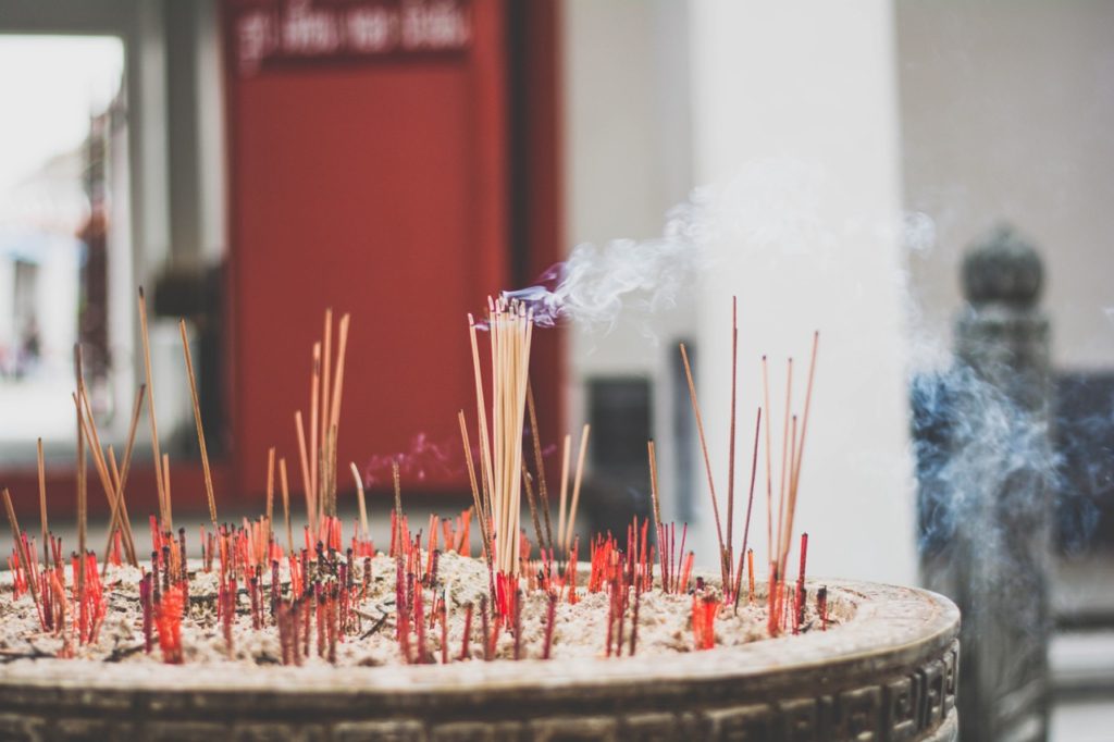 Insense sticks burn at a temple in Thailand