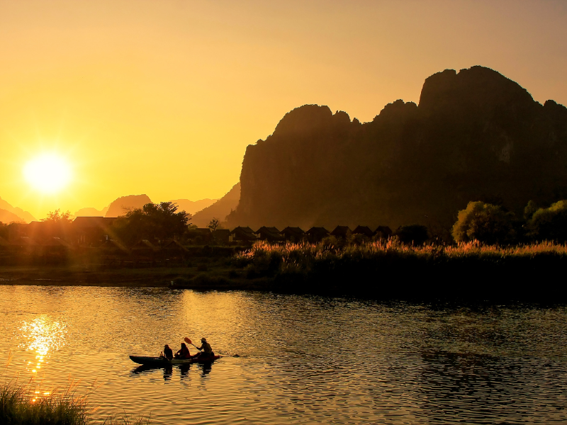 Landscape of Vang Vieng with people kayaking