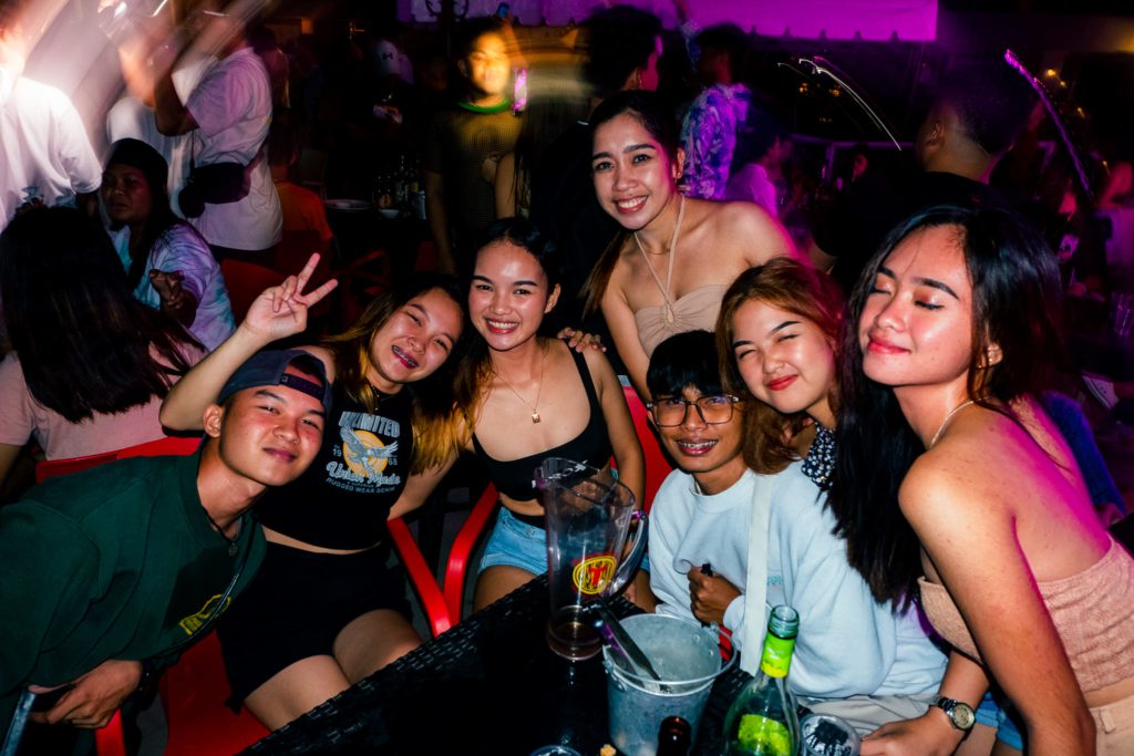 young people drinking at tiki bar in dumaguete