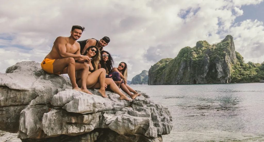 Travelers exploring limestone cliffs in a Palawan Travel Guide.