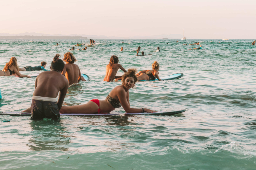 Surf students paddling out during a lesson at Kuta Lombok Surf Camp