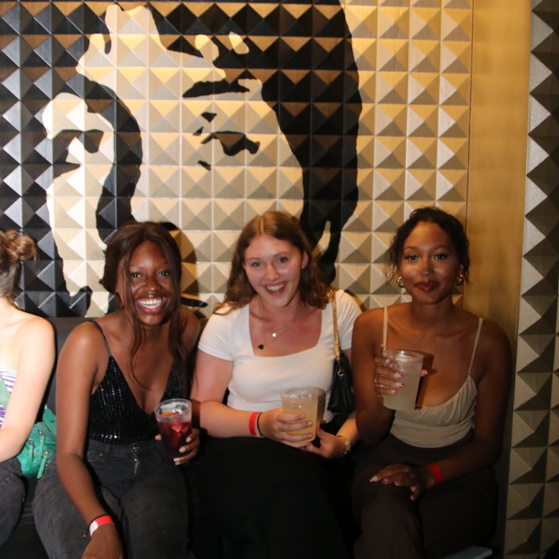 Travelers enjoying drinks together at Sant Jordi Hostels, one of the social hostels in Europe.